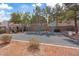 Swings and covered seating at the community playground with drought resistant landscaping and shade trees at 9153 Beauchamp Ave, Las Vegas, NV 89148