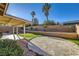 Backyard featuring a lawn area and a crushed gravel area with mature landscaping at 917 Pigeon Forge Ave, Henderson, NV 89015