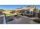 Private backyard oasis featuring a covered patio, artificial turf, desert landscaping, and a charming water fountain at 917 Pigeon Forge Ave, Henderson, NV 89015