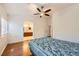 Bedroom with wood floors leading to bathroom with dual sinks and wood cabinets at 917 Pigeon Forge Ave, Henderson, NV 89015