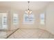 Bright dining area featuring tile flooring, large windows with shutters, and a stylish chandelier at 917 Pigeon Forge Ave, Henderson, NV 89015