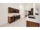 Well-equipped kitchen featuring stainless steel appliances, dark cabinetry, and an adjacent dining area at 917 Pigeon Forge Ave, Henderson, NV 89015