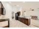 Open-concept kitchen featuring stainless steel appliances, dark cabinets, and a seamless flow to the living area at 917 Pigeon Forge Ave, Henderson, NV 89015