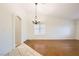 Bright, airy living room featuring modern light fixture, hardwood floors and expansive windows at 917 Pigeon Forge Ave, Henderson, NV 89015