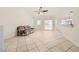 Open living room featuring tile flooring, bright natural light, and neutral wall paint at 917 Pigeon Forge Ave, Henderson, NV 89015