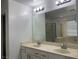 Bathroom with double sink vanity, a large mirror, and modern lighting at 953 Via Gandalfi, Henderson, NV 89011
