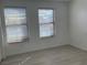 Bright bedroom featuring two windows and light-colored flooring at 953 Via Gandalfi, Henderson, NV 89011