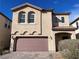 Charming two-story home featuring a brown garage door and desert landscaping at 953 Via Gandalfi, Henderson, NV 89011