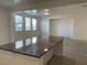 Kitchen island with granite countertop adjoins a living room with ample sunlight at 953 Via Gandalfi, Henderson, NV 89011