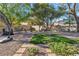 A spacious backyard features a variety of seating arrangements and manicured landscaping at 9768 Northern Dancer Dr, Las Vegas, NV 89117