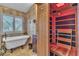 Bathroom features a sauna, standalone tub, and tiled wall at 9768 Northern Dancer Dr, Las Vegas, NV 89117