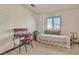 Bright bedroom featuring a daybed, desk, and carpet at 9768 Northern Dancer Dr, Las Vegas, NV 89117
