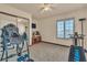 Bedroom featuring mirrored closet, carpet, and exercise equipment at 9768 Northern Dancer Dr, Las Vegas, NV 89117
