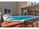 Backyard hot tub featuring water jets, a wooden surround, and ample space for relaxation at 9768 Northern Dancer Dr, Las Vegas, NV 89117