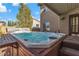 Hot tub with blue water featuring wooden surround and steps leading into the spa at 9768 Northern Dancer Dr, Las Vegas, NV 89117