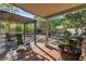 Covered patio with lounge chairs, a ceiling fan, and mature landscaping at 9768 Northern Dancer Dr, Las Vegas, NV 89117
