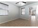 Relaxing bedroom with tile floors and natural light, complemented by a view of the hallway at 9807 Sage Canyon St, Las Vegas, NV 89178
