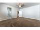 Bedroom with neutral paint, plush carpet, ceiling fan and an ensuite bathroom with a glass shower at 9807 Sage Canyon St, Las Vegas, NV 89178