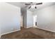 Bedroom with neutral paint, plush carpet, a ceiling fan, and doorways leading to other rooms at 9807 Sage Canyon St, Las Vegas, NV 89178