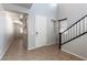 Bright entryway with tile flooring, a staircase, and natural light from a window at 9807 Sage Canyon St, Las Vegas, NV 89178