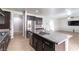 Kitchen island with granite countertops, stainless steel appliances, and a seamless open flow to the living area at 9807 Sage Canyon St, Las Vegas, NV 89178