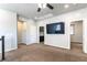 Upstairs landing featuring neutral paint, plush carpet, ceiling fan, and entertainment center at 9807 Sage Canyon St, Las Vegas, NV 89178