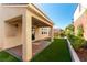 Covered patio with brick flooring, ceiling fan, and views of the landscaped backyard at 9807 Sage Canyon St, Las Vegas, NV 89178