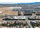This aerial view showcases a residential area near the South Point Casino and mountains in the distance at 9967 Pipestone St, Las Vegas, NV 89141