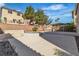 Expansive backyard showcasing a water feature, a built in BBQ, and a covered patio area at 9967 Pipestone St, Las Vegas, NV 89141