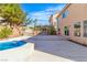 Backyard featuring a refreshing pool, outdoor kitchen, and covered gazebo, creating an ideal space for relaxation and entertainment at 9967 Pipestone St, Las Vegas, NV 89141