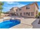 Large backyard with a sparkling pool, patio, and a well-maintained lawn creating a perfect outdoor oasis at 9967 Pipestone St, Las Vegas, NV 89141
