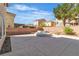 Spacious backyard featuring a water feature, brick walls, and manicured landscaping at 9967 Pipestone St, Las Vegas, NV 89141