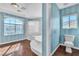 Bathroom featuring a tub and shower, with large windows providing natural light at 9967 Pipestone St, Las Vegas, NV 89141