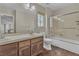 Bathroom with wood-look flooring, a double sink vanity, and a shower over tub at 9967 Pipestone St, Las Vegas, NV 89141