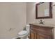 Bathroom features a vanity with marble countertop, toilet, and classic neutral walls at 9967 Pipestone St, Las Vegas, NV 89141