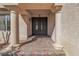 Inviting front entrance featuring a secure metal gate, decorative columns, and stylish brickwork leading to the door at 9967 Pipestone St, Las Vegas, NV 89141
