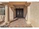 Close-up of the front door featuring paver steps, elegant pillars, an iron security door and decorative outdoor lighting at 9967 Pipestone St, Las Vegas, NV 89141
