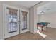 Bright game room with pool table, tiled floors, and double doors leading to the backyard area at 9967 Pipestone St, Las Vegas, NV 89141