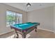 Bright game room featuring a pool table, tiled floors, natural light and neutral paint at 9967 Pipestone St, Las Vegas, NV 89141