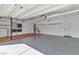 Spacious three-car garage with epoxy flooring, built in shelves, and ample storage space at 9967 Pipestone St, Las Vegas, NV 89141