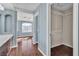 Hallway with blue-striped walls and hardwood floors, leading to the en-suite bathroom and closet at 9967 Pipestone St, Las Vegas, NV 89141
