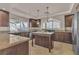 Modern kitchen with stainless steel appliances and an island provides plenty of counter space at 9967 Pipestone St, Las Vegas, NV 89141