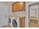 Well-equipped laundry room with modern washer, dryer, and convenient storage at 9967 Pipestone St, Las Vegas, NV 89141