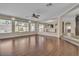 Bright and airy living room featuring hardwood floors, a ceiling fan, many windows, and an open layout at 9967 Pipestone St, Las Vegas, NV 89141