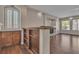 Open-concept living space featuring hardwood floors, columns, built-ins, natural light and neutral paint at 9967 Pipestone St, Las Vegas, NV 89141