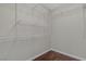 Walk-in closet with white shelving and wood-look flooring at 9967 Pipestone St, Las Vegas, NV 89141
