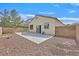 Private backyard featuring a concrete patio, rock landscaping, block wall and a sliding glass door at 100 Beaver Falls Ave, Las Vegas, NV 89123
