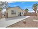 Backyard featuring a concrete patio, rock landscaping, block wall, and an outdoor gated access at 100 Beaver Falls Ave, Las Vegas, NV 89123