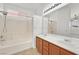 Bright bathroom featuring double vanity with a shower and bathtub combination at 100 Beaver Falls Ave, Las Vegas, NV 89123