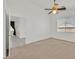 Bright bedroom featuring neutral carpet, a ceiling fan, and ample natural light at 100 Beaver Falls Ave, Las Vegas, NV 89123